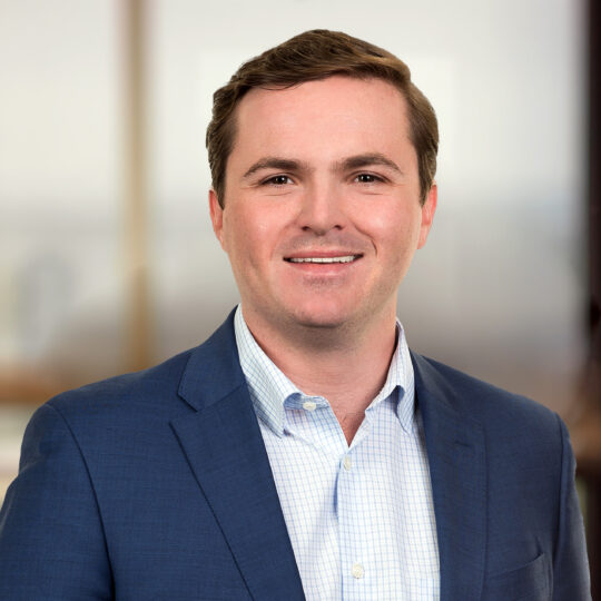 Professional headshot of Christian Amato, Capital Markets Associate at Brennan Investment Group, smiling in business attire.
